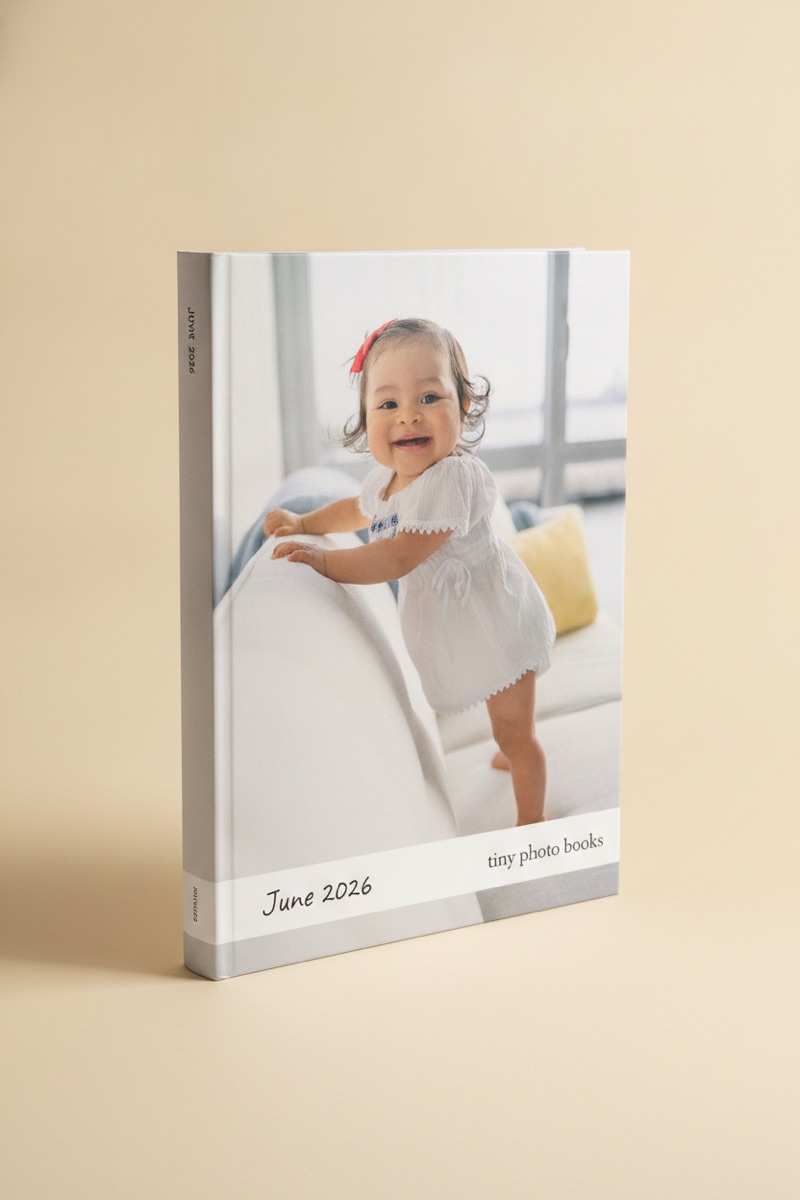 A single monthly book standing upright, June 2026 on the cover under a photo of a baby, printed spine visible